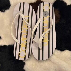 Calvin Klein Black and White Flip Flops with Yellow Logo